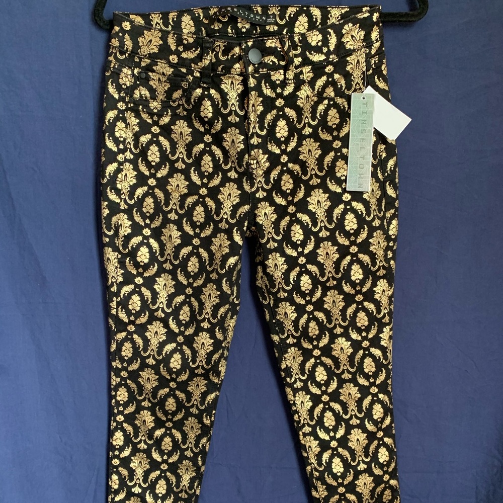 gold and black pants with designs